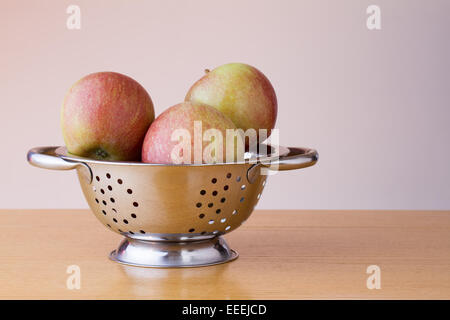 Ripe braeburn apples in a colander Stock Photo
