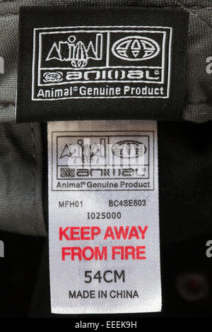 Animal Genuine Product keep away from fire Made in China label in black baseball cap - sold in the UK United Kingdom, Great Britain Stock Photo