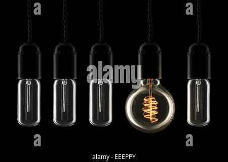 Vintage style lightbulbs with one turned on Stock Photo