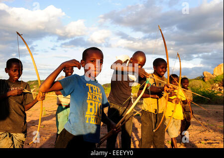 TANZANIA, Kondoa, children of Sandawe a hunter tribe play with bow and arrow Stock Photo