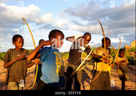 TANZANIA, Kondoa, children of Sandawe a hunter tribe play with bow and arrow Stock Photo