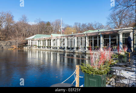 View of Loeb Boathouse lakeside eatery and bar with reflection in The Lake in Central Park, Manhattan, New York in winter with blue sky on a sunny day Stock Photo