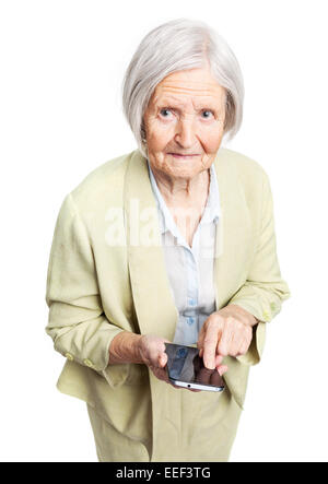 Senior woman holding mobile phone and looking at camera over white Stock Photo