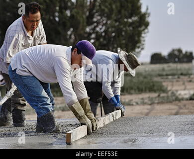 Prescott, Arizona, USA -- January 1, 2015: Construction workers finishing new cement slab. Stock Photo