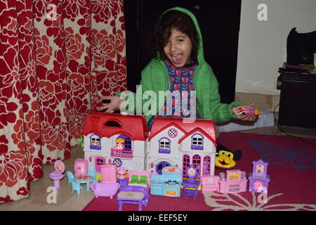 Little girl playing with her doll house Stock Photo