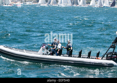 sydney police officers patrolling the harbour during the start of the sydney to hobart 2014 yacht race Stock Photo