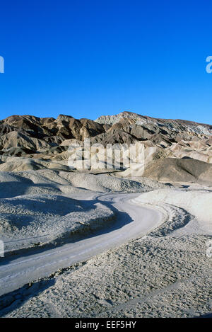 Death Valley National Park, California, CA, USA - Dirt Road winding through Eroded Landscape in Twenty Mule Team Canyon Stock Photo