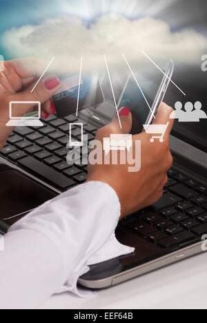 Woman holding credit card and phone, cloud computing technology concept Stock Photo