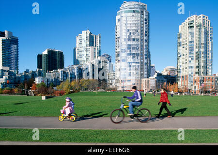 Yaletown, Vancouver, BC, British Columbia, Canada - Family cycling and walking on a Path through David Lam Park, Autumn Stock Photo