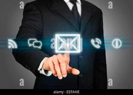 Businessman clicking on email icon Stock Photo
