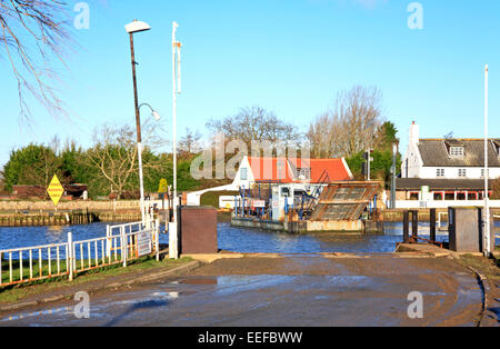 A view of Reedham Ferry with vehicle aboard completing a crossing over the River Yare on the Norfolk Broads, England, UK. Stock Photo