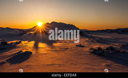 Sun setting behind the Ahkka massif in Stora Sjöfallet National Park Stock Photo