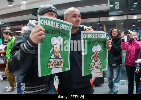 Berlin, Germany. 17th Jan, 2015. Kenny Rebenstock (L) and Nico Hirte (R) hold copies of the French satirical magazine 'Charlie Hebdo' in the central station of Berlin, Germany, 17 January 2015. They had waited in front of the bookshop since midnight, to get the only two copies at 5 in the morning. PHOTO: MAURIZIO GAMBARINI/dpa/Alamy Live News Stock Photo