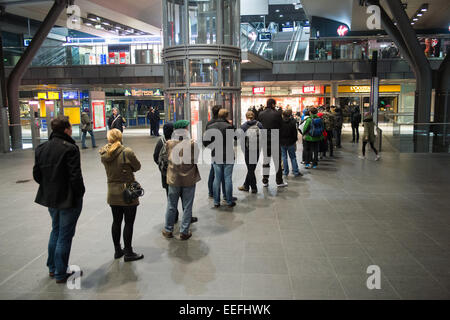 Berlin, Germany. 17th Jan, 2015. People stand in line, waiting for a station bookshop to open, to buy a copy of the French satirical magazine 'Charlie Hebdo' at the central station in Berlin, Germany, 17 January 2015. Photo: Maurizio Gambarini/dpa/Alamy Live News Stock Photo
