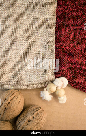 two colors burlap bag with white cotton laces and two nuts close up Stock Photo