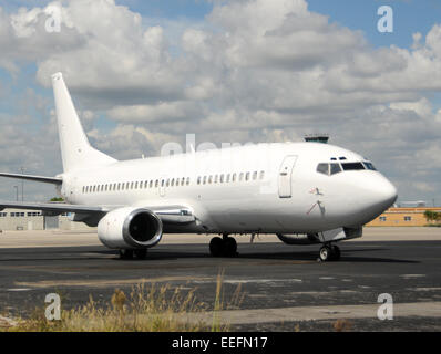 Modern passenger jet airplane in unmarked white paint Boeing 737 Stock Photo