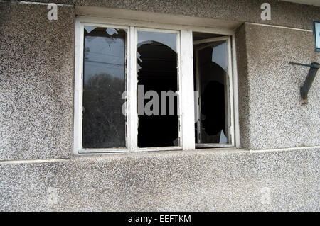 The old wooden three-bladed window with broken glass. Stock Photo