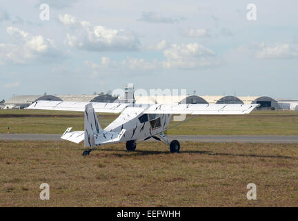 Light private airplane taxiing on the ground rear view Stock Photo