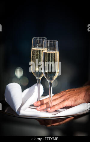 Glasses of champagne served on tray Stock Photo