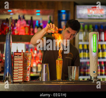 A barman making a flaming cocktail Stock Photo
