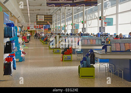 Tesco Extra supermarket store interior view of long aisle of check out points on a quiet early morning just after New Year holidays London England UK Stock Photo