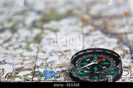 Compass and map. The magnetic compass is located on a topographic map ...