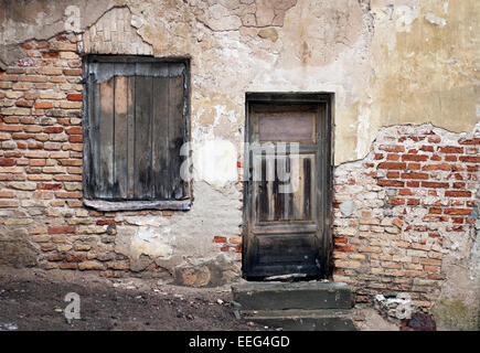 Old window and door with cracked wall Stock Photo