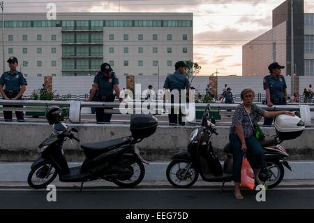 Manila, Philippines, 16th Jan, 2015. A woman takes her rest in one of the Police motorcycle while waiting for the Pope. Credit:  Mark Z. Saludes/Pacific Press/Alamy Live News Stock Photo