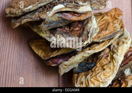 dried porcini mushrooms on wooden background Stock Photo