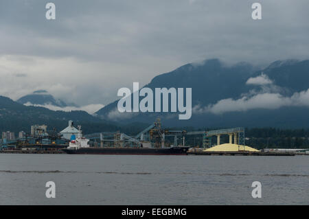 Giant pile of sulphur at Vancouver Wharves bulk marine terminal ready for shipment around the world for use in fertilizers Stock Photo