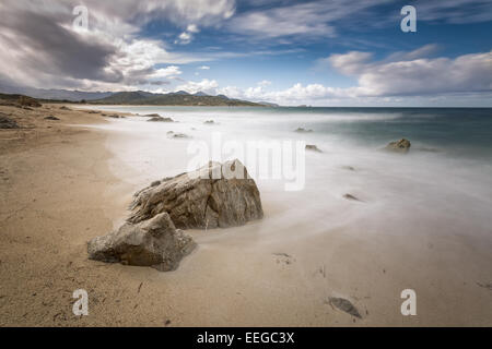 Slow shutter speed shot of Lozari beach in the Balagne region of northern Corsica with Ile Rousse in the background Stock Photo