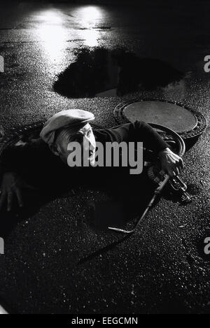 Hamburg, Germany, burglar creeping out Gully Stock Photo