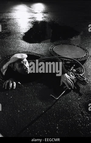 Hamburg, Germany, burglar creeping out Gully Stock Photo