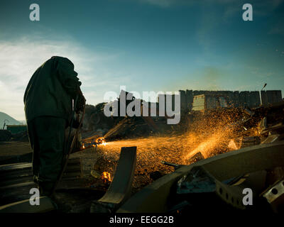 worker wearing protective equipment welding metal outdoors. copy space available Stock Photo