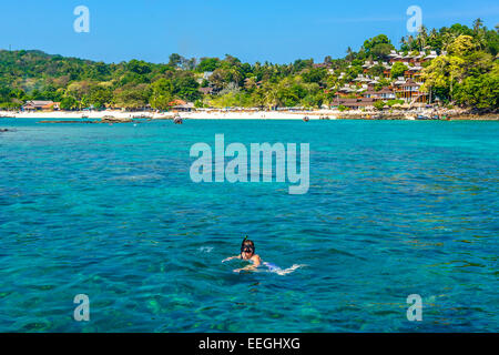 Tourist in the Adaman sea , Thailand snorkeling in exceptionaly clear water with underwater colourful coral and exotic fish Stock Photo