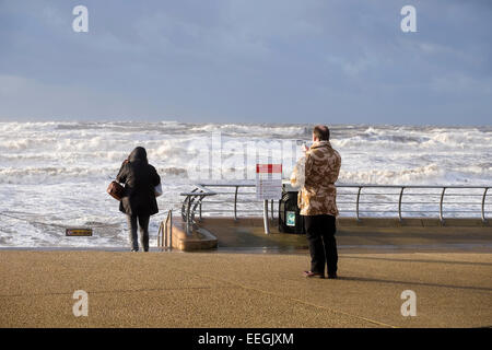 Blackpool, Lancashire: A bracing walk along Blackpool's promenade during gales and high-tide. Stock Photo