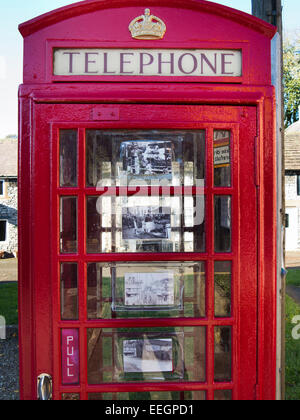 UK, Derbyshire, Tideswell, Fountain Square, old K6 Phone Box used toi display local heritage photographs