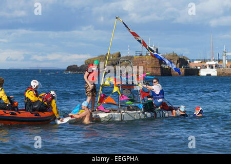 A colourful raft attended by the RNLI inshore lifeboat in a raft race at North Berwick, East Lothian, Scotland. Stock Photo