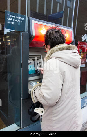 Senior woman at a cash point machine. Stock Photo