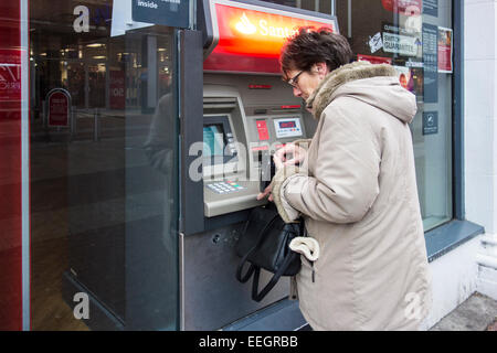 Senior woman at a cash point machine. Stock Photo