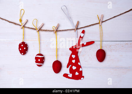 A Red Easter Bunny With Hearts Hanging On A Line With Four Red Easter Eggs Which Are Dotted And Striped On White Wooden Vintage Stock Photo