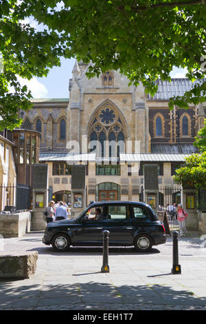 London taxi passing Southwark Cathedral in London England Stock Photo