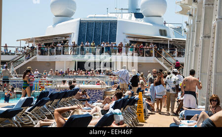 Pool deck of a luxury cruise ship crowded with tourists Stock Photo