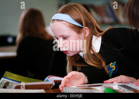 School girl studying books in library Stock Photo