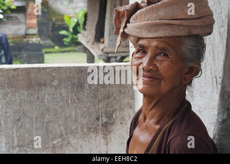 Elderly Balinese lady in traditional dress outside her home. Stock Photo