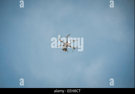 A civil Unmanned Aerial Vehicle (UAV) / multicopter drone used for aerial surveillance is flying in the air Stock Photo