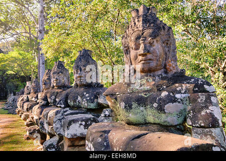 Bayon temple stone carvings along the bridge Stock Photo