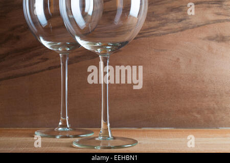 Two glasses of wine on the wooden background from real wood veneer with interesting growth Stock Photo