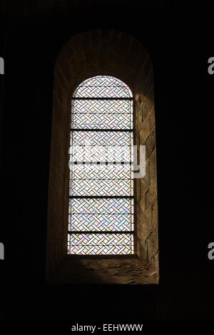 Simple stained glass window Abbatiale St. Pierre St. Paul de Solignac. Stock Photo