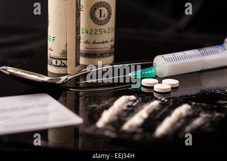 Drugs, cocaine, syringe and heroin on spoon ready for use Stock Photo